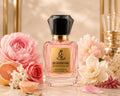 A bottle of Blossom Vibe Royal Essence Extrait de Parfum by Gucci Flora, styled with pink and white flowers, citrus slices, and gold decorative elements on a reflective surface.