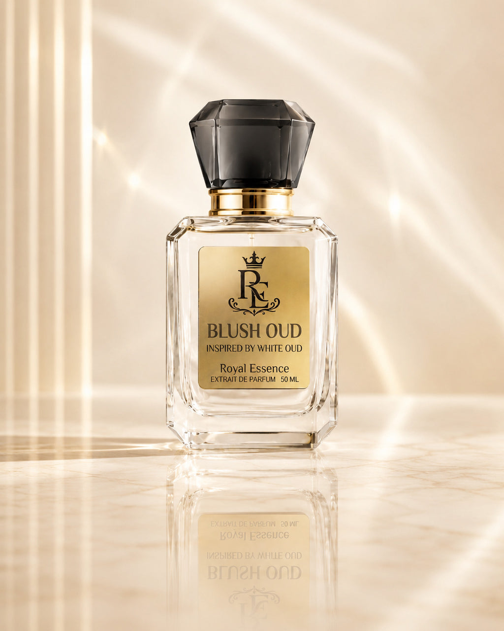 A 50ml bottle of Royal Essence Blush Oud Extrait de Parfum, featuring a clear glass body, a gold label with a black monogram logo, and a faceted black cap, set against a warm beige background with elegant light rays and a soft reflection.