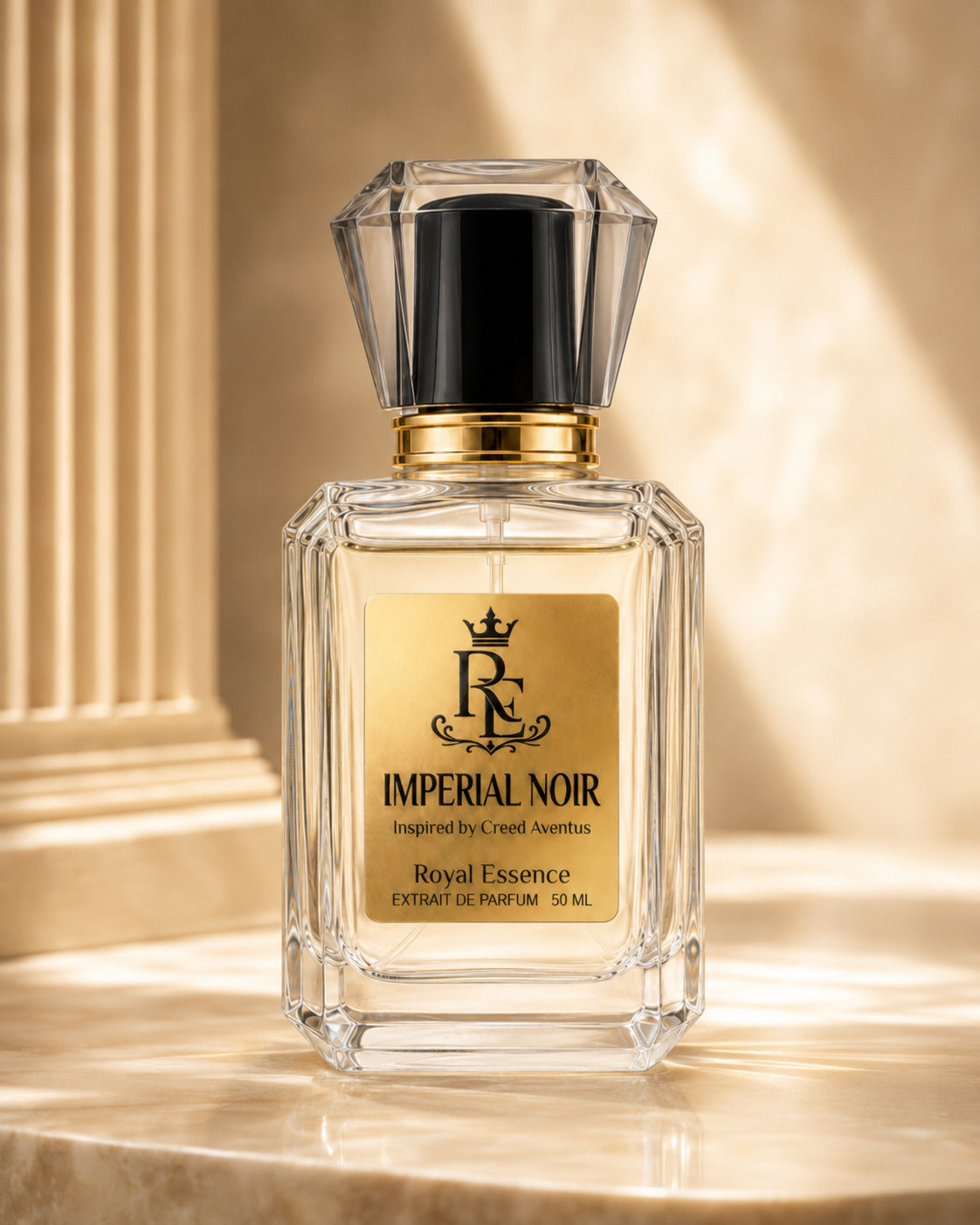 A clear glass perfume bottle with a black cap and gold label reading 'Imperial Noir' and 'Royal Essence', placed on a warm beige marble surface with a classical column background.